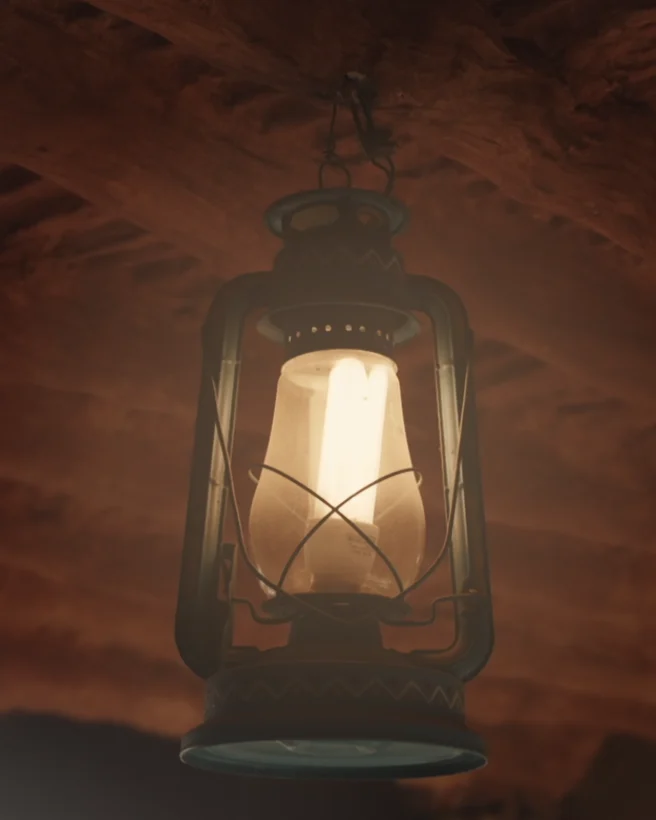 A lantern hanging under a timber roof, from the Qemam festival films